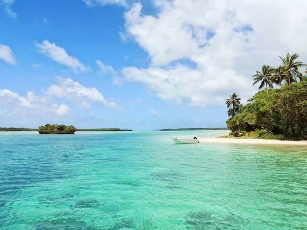 Pristine turquoise lagoon and tropical island boat