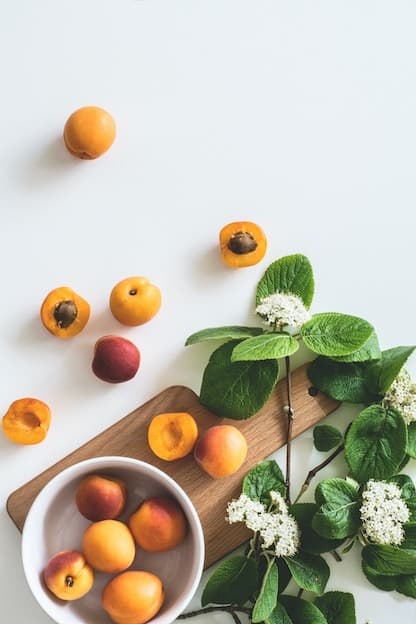 Fresh organic apricots flatlay on wooden board