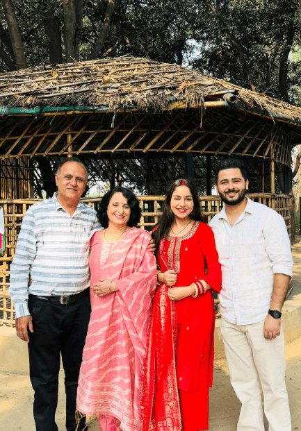 Happy Indian family portrait enjoying togetherness outdoors