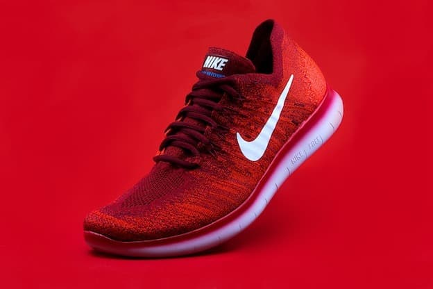 Red athletic running sneaker product shot