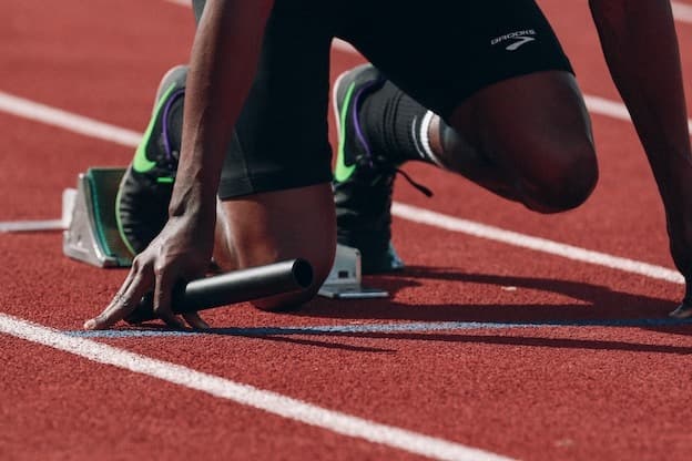 Track sprinter on starting blocks ready to race
