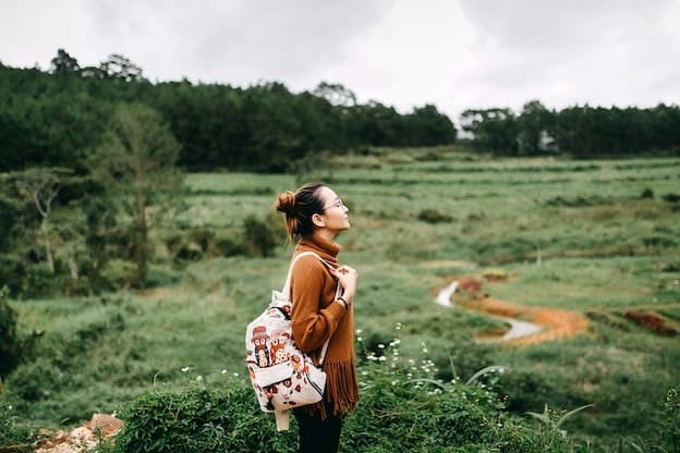 Solo traveler enjoying mountain valley