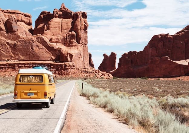Yellow adventure camper van in canyon desert