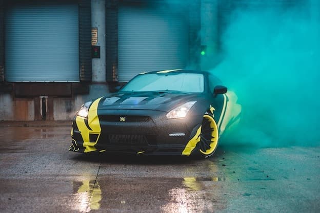 Nissan GT-R sports car doing green smoke tire drift